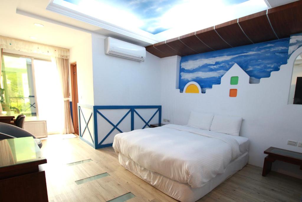 Postel nebo postele na pokoji v ubytování 墾丁貝殼灣旅店