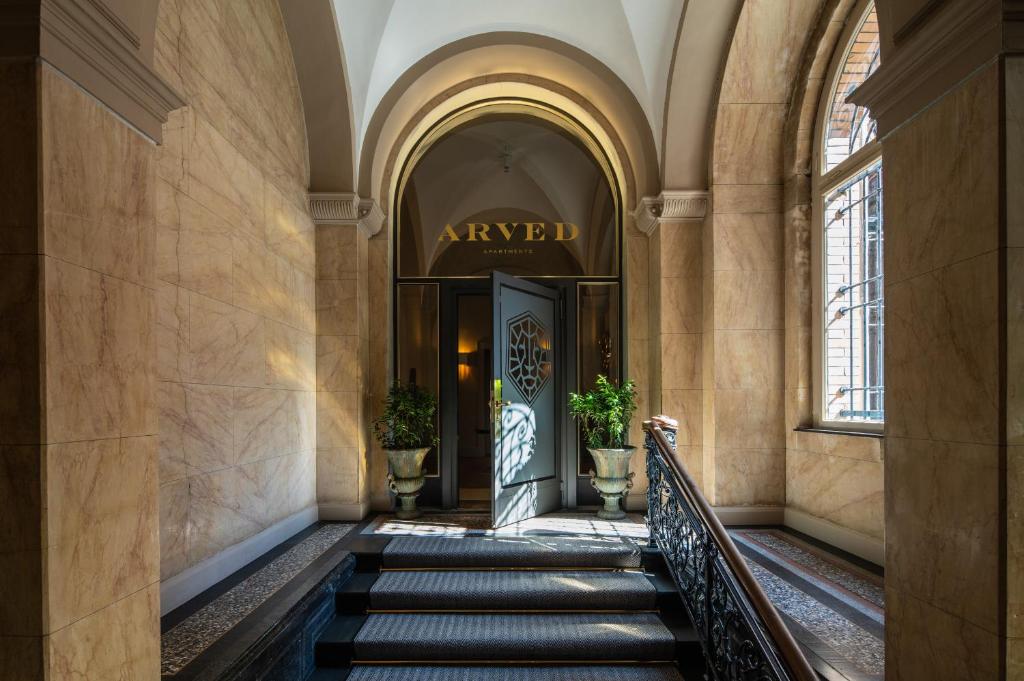 a hallway of a building with a door and stairs at ARVED Apartments in Lübeck