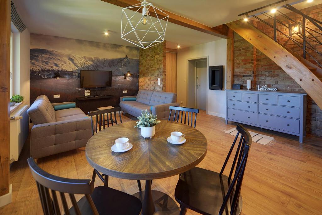 ein Esszimmer und ein Wohnzimmer mit einem Tisch und Stühlen in der Unterkunft Apartamenty Sun Seasons 24 - Willa Karpacz in Karpacz