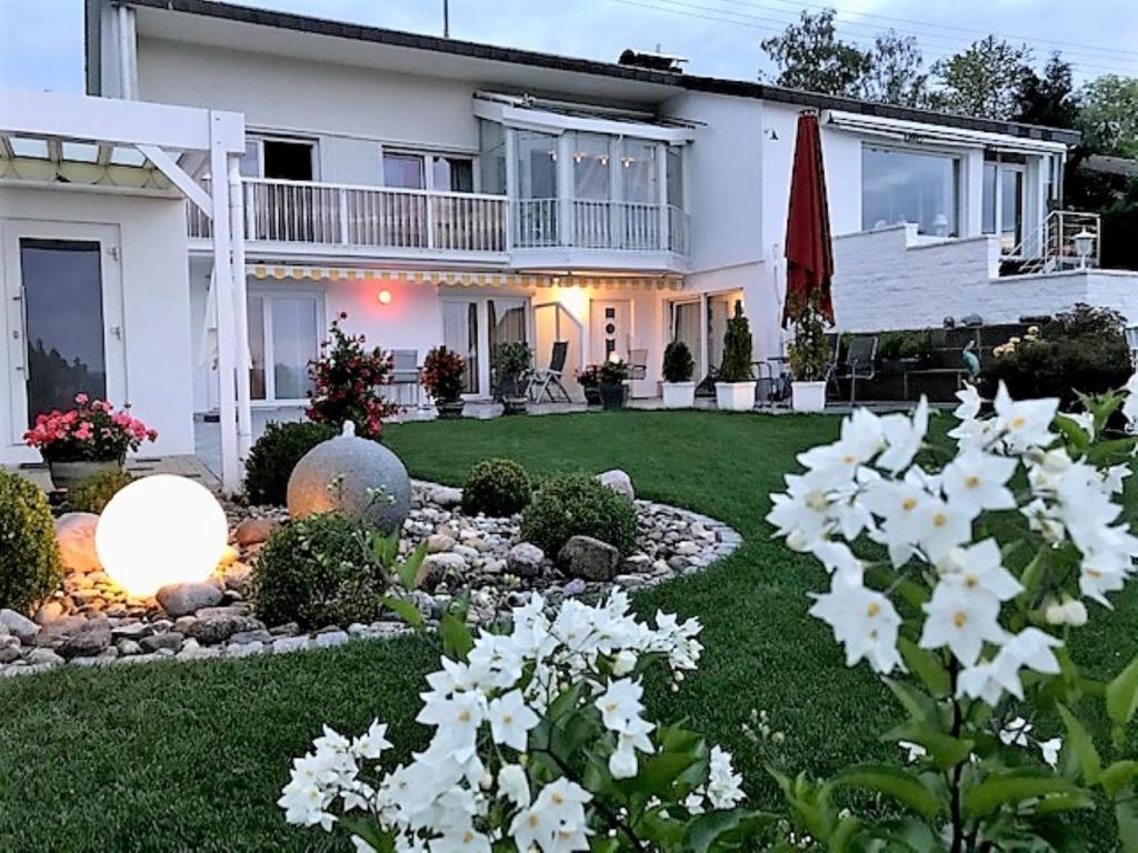 una casa con un patio con flores blancas en Haus Ketterer en Bad Dürrheim