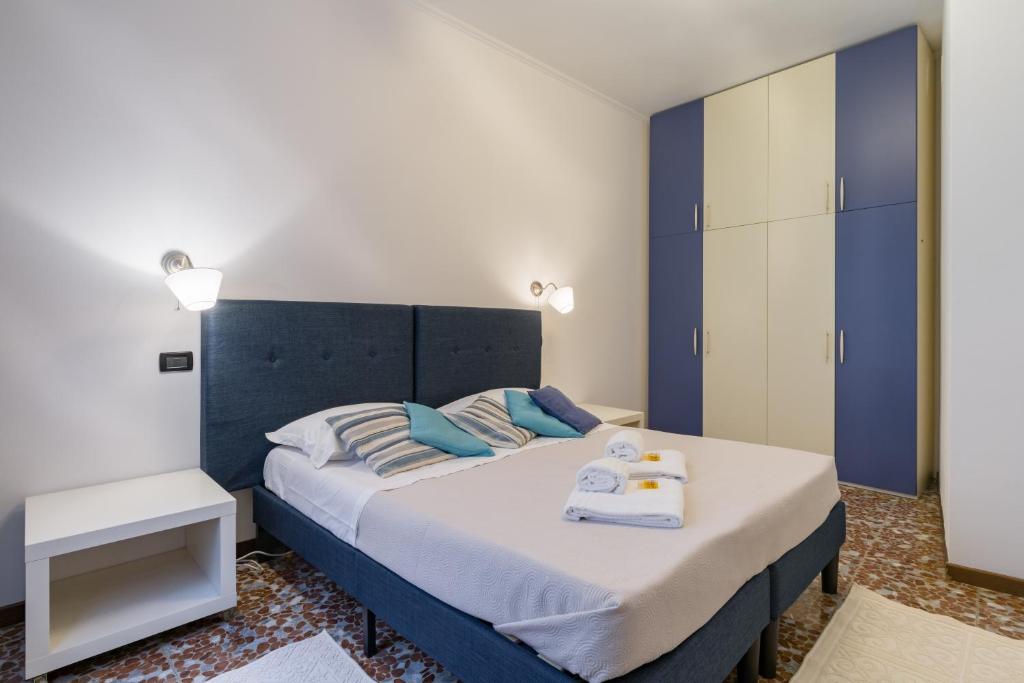 1 dormitorio con 1 cama con cabecero azul en SUITE CRISTINA en Verona
