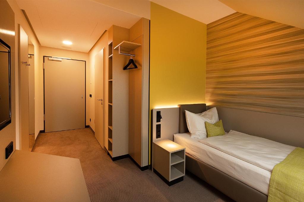 Postel nebo postele na pokoji v ubytování th Hotel Leipzig Messe