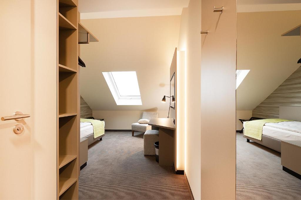 Postel nebo postele na pokoji v ubytování th Hotel Leipzig Messe