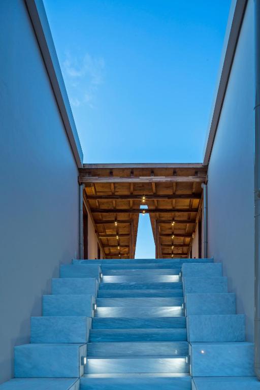 a set of blue stairs with a blue sky in the background at Horizon Blu Boutique Hotel in Kalamata