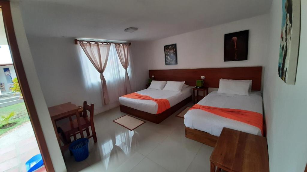 Postel nebo postele na pokoji v ubytování HOSTAL TERO REAL