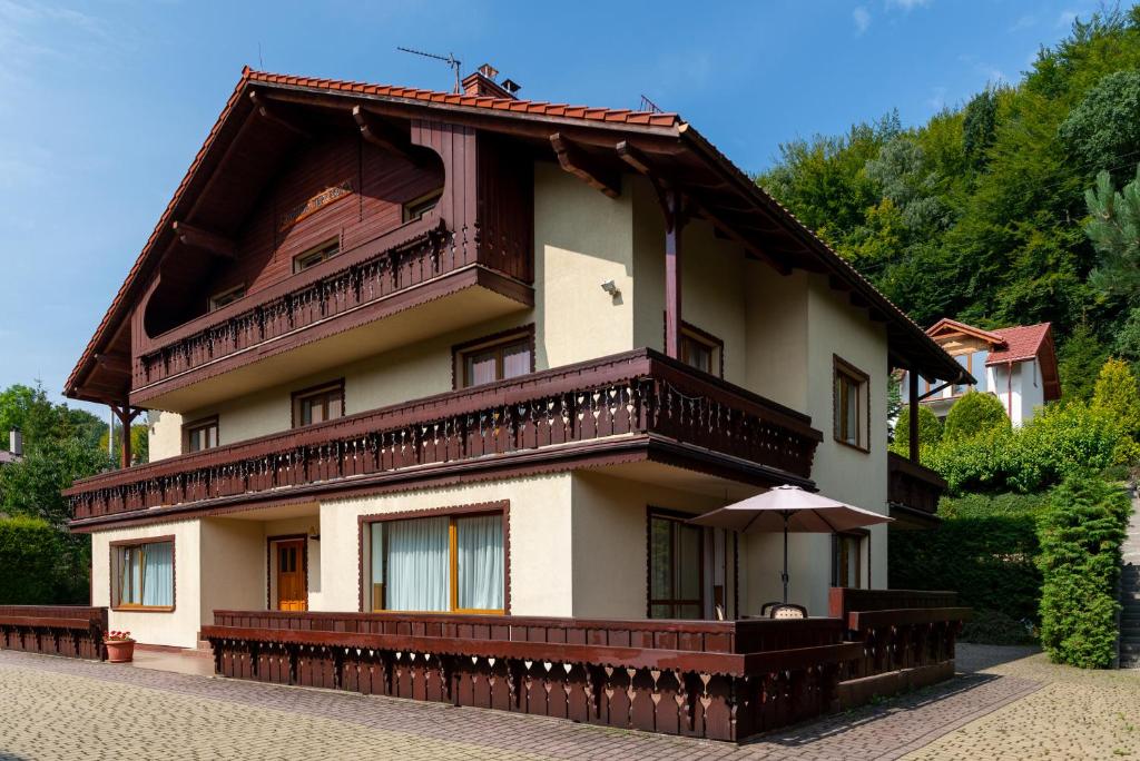 a large house with a balcony on top of it at Willa Jerrego in Szczyrk