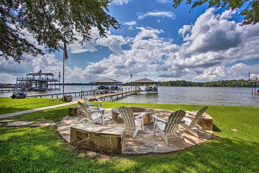 a group of chairs sitting on the grass near the water at Idyllic Remodeled Lakefront Retreat with Fire Pit! in Malakoff