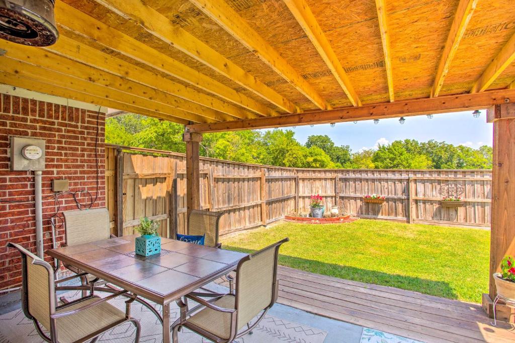 a patio with a wooden pergola with a table and chairs at Family-Friendly Rowlett Home about 23 Mi to Dallas in Rowlett