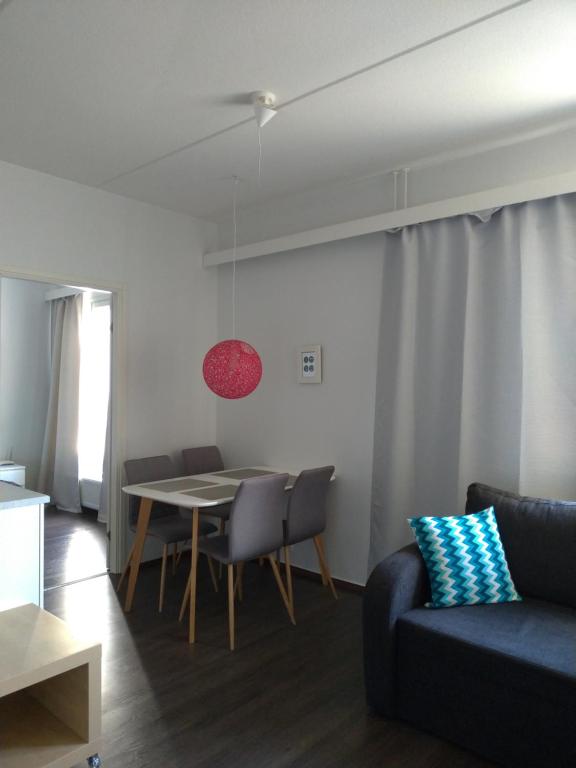 a living room with a table and a couch at City Apartments in Jyväskylä