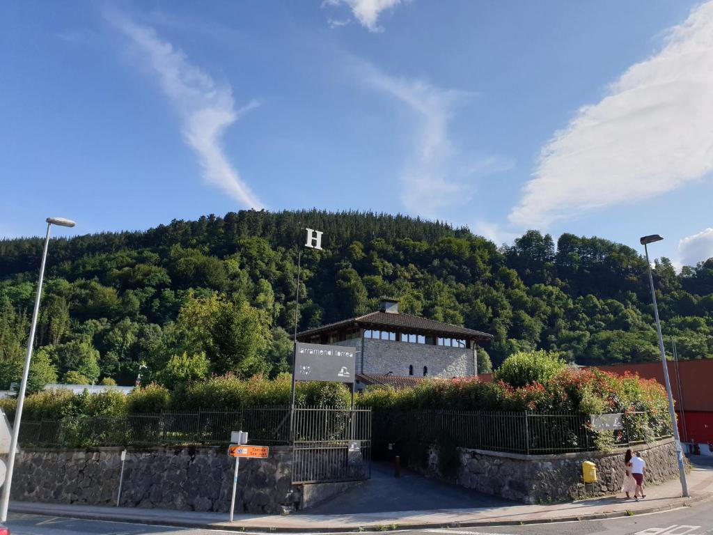 un edificio en la cima de una colina con árboles en Larramendi Torrea, en Azcoitia