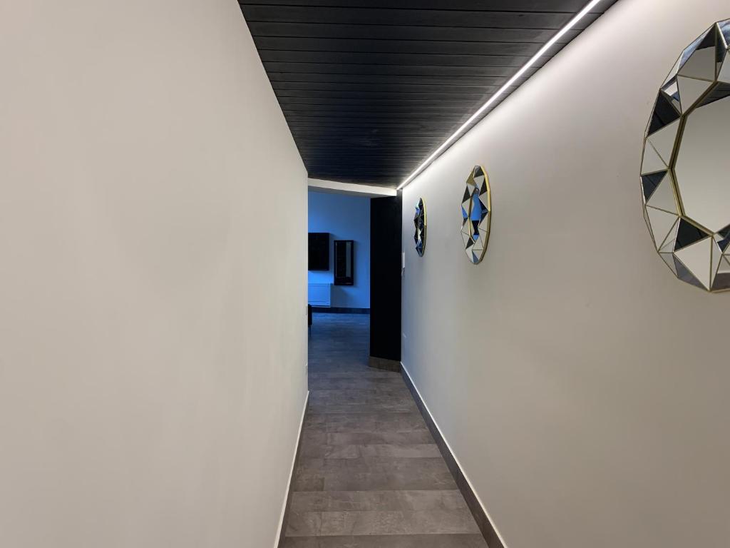a hallway with white walls and a black ceiling at Neko Boutique Hotel in Cagliari