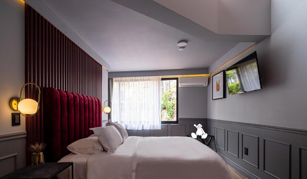 Postel nebo postele na pokoji v ubytování Casa Nada Hotel