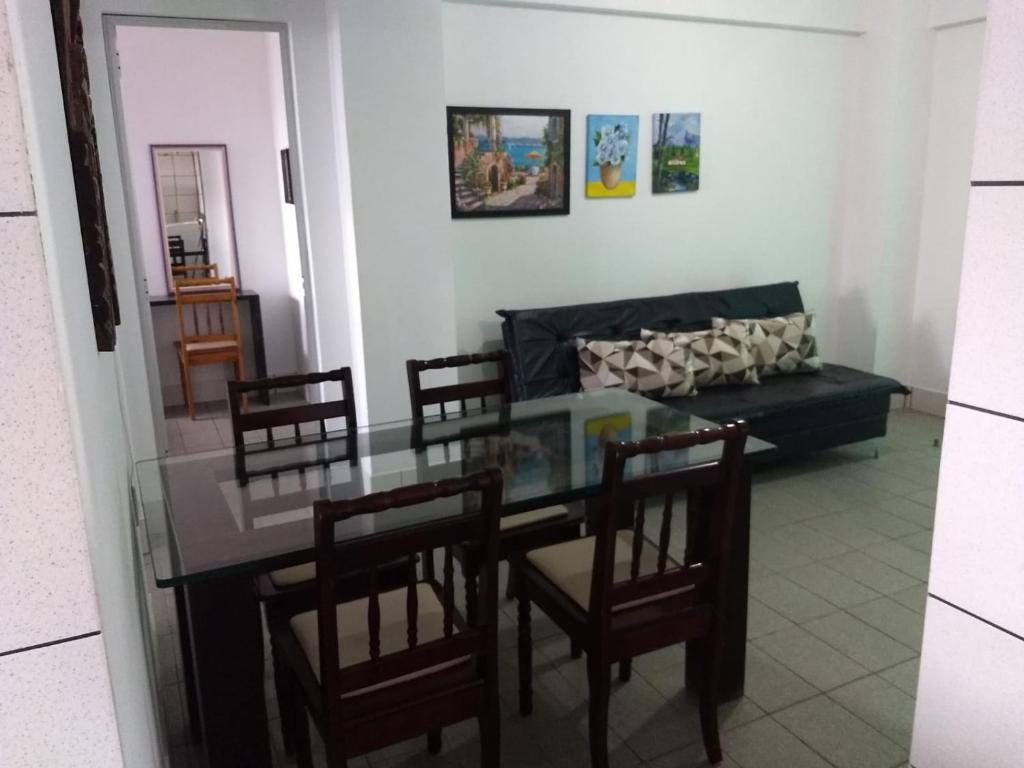 ein Esszimmer mit einem Glastisch und Stühlen in der Unterkunft PRAIA DE 4 ILHAS Apartamento 2 Quartos 60M Da Praia Com Vista in Bombinhas