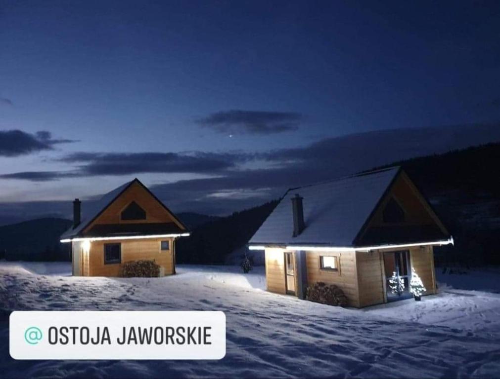 a couple of buildings in the snow at night at Ostoja Jaworskie in Stryszawa