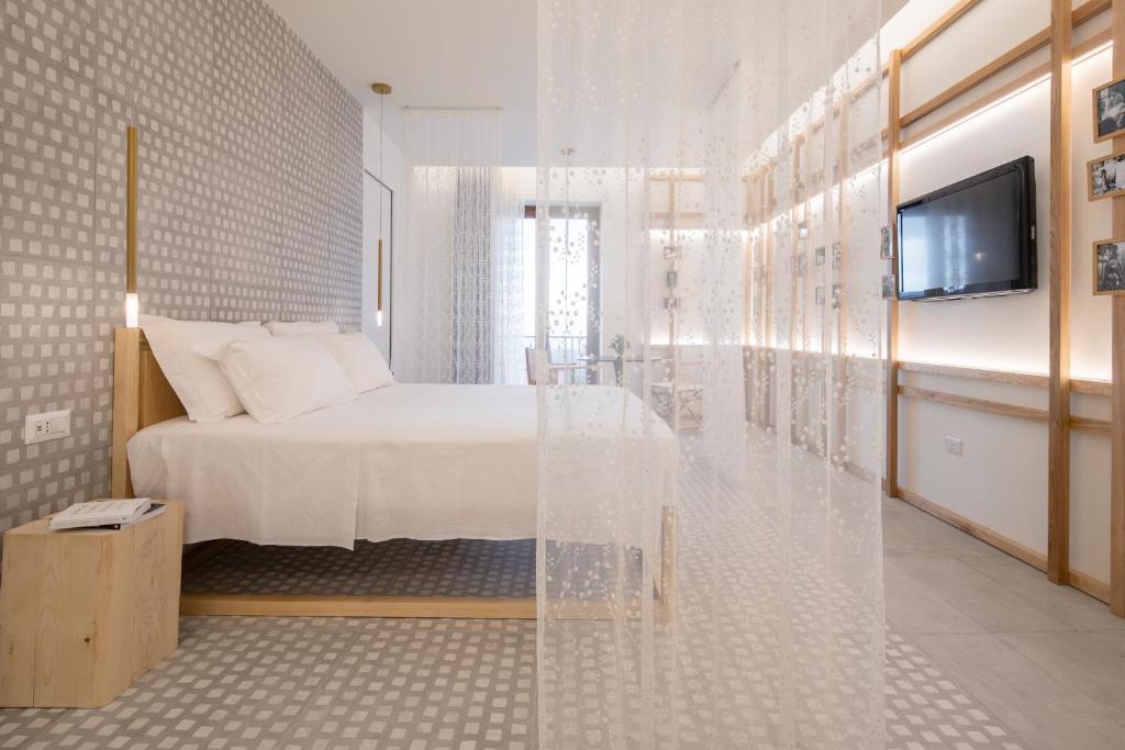 Postel nebo postele na pokoji v ubytování Terra del Sasso Suites - Design Architetto Salvatore Spataro
