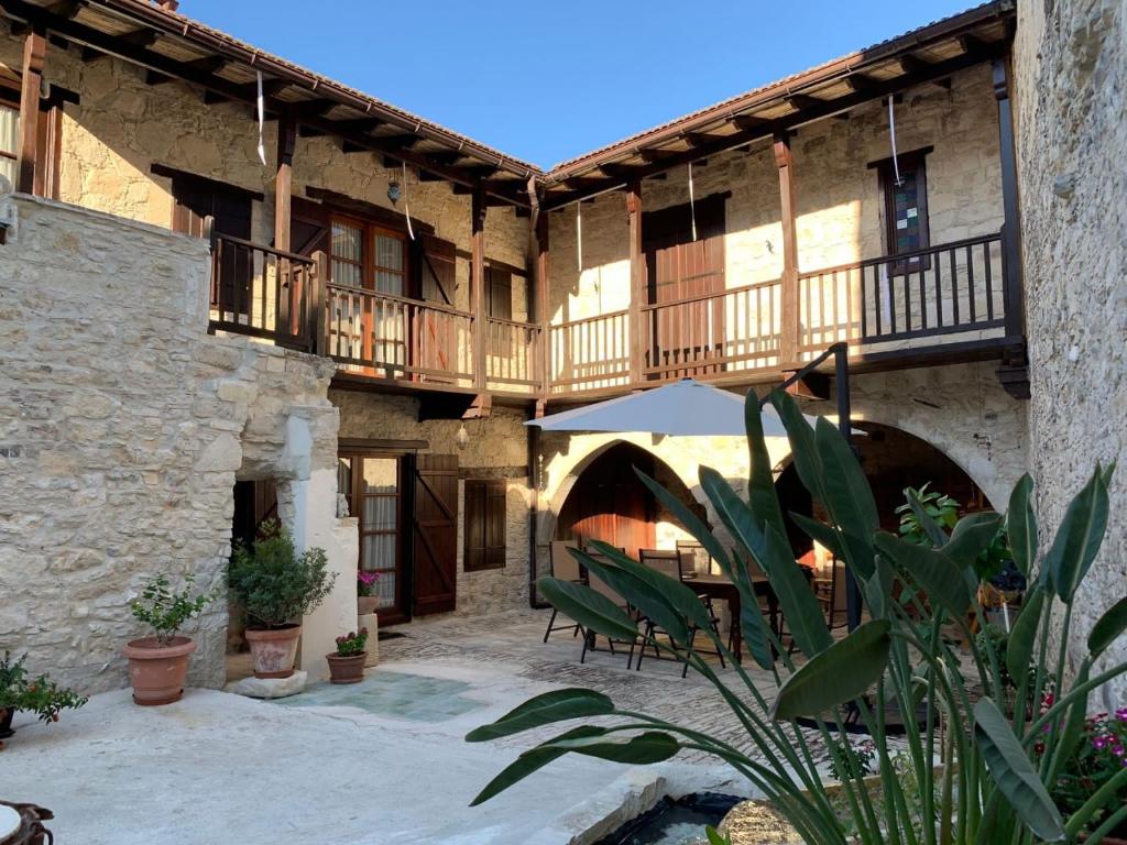 an outdoor patio with tables and chairs in a building at Afames House - Beautiful Traditional House in Omodos