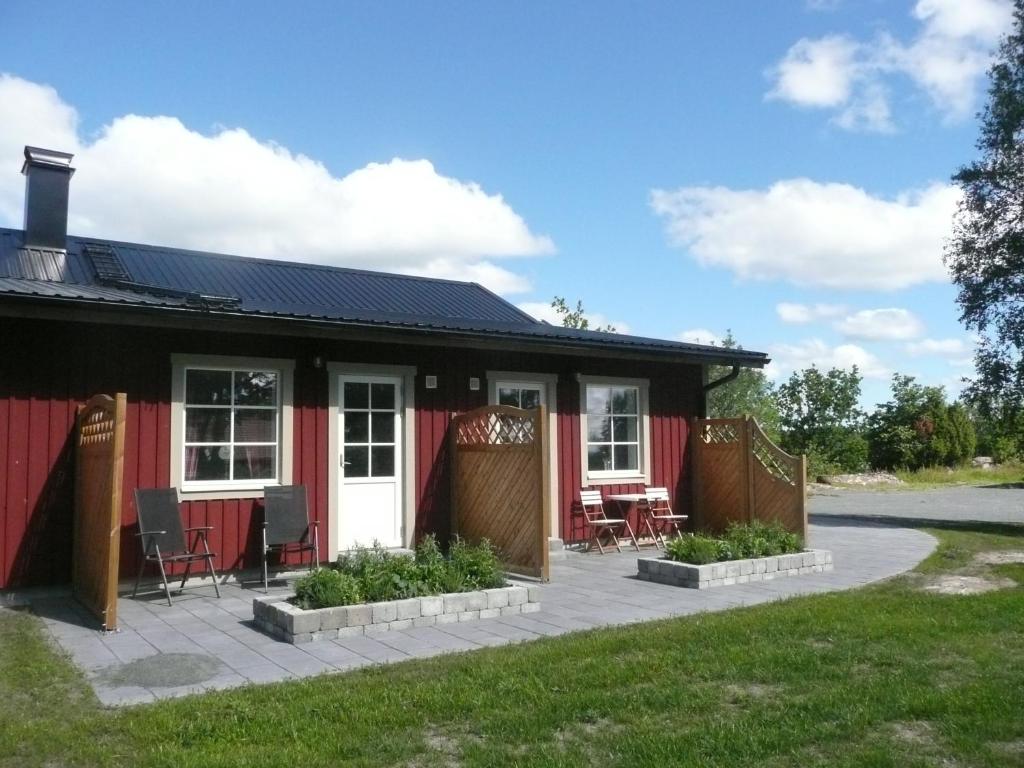 a red house with a patio in front of it at Kullens Bed and Breakfast in Mellby