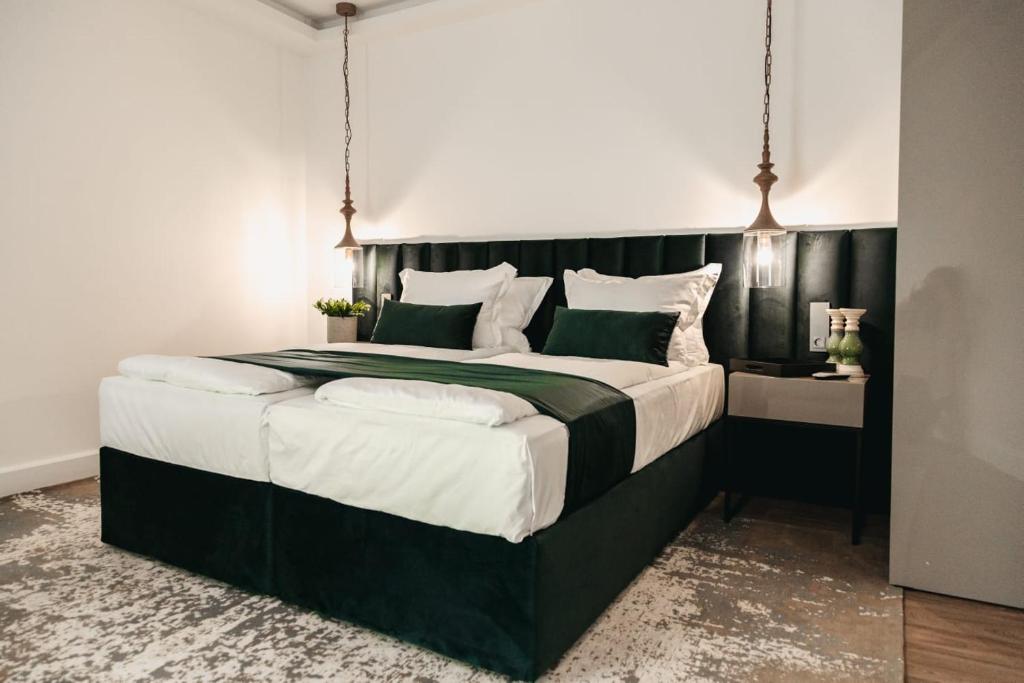 a bedroom with a large bed with a black headboard at The Berg's 4 in Ocna-Mureşului