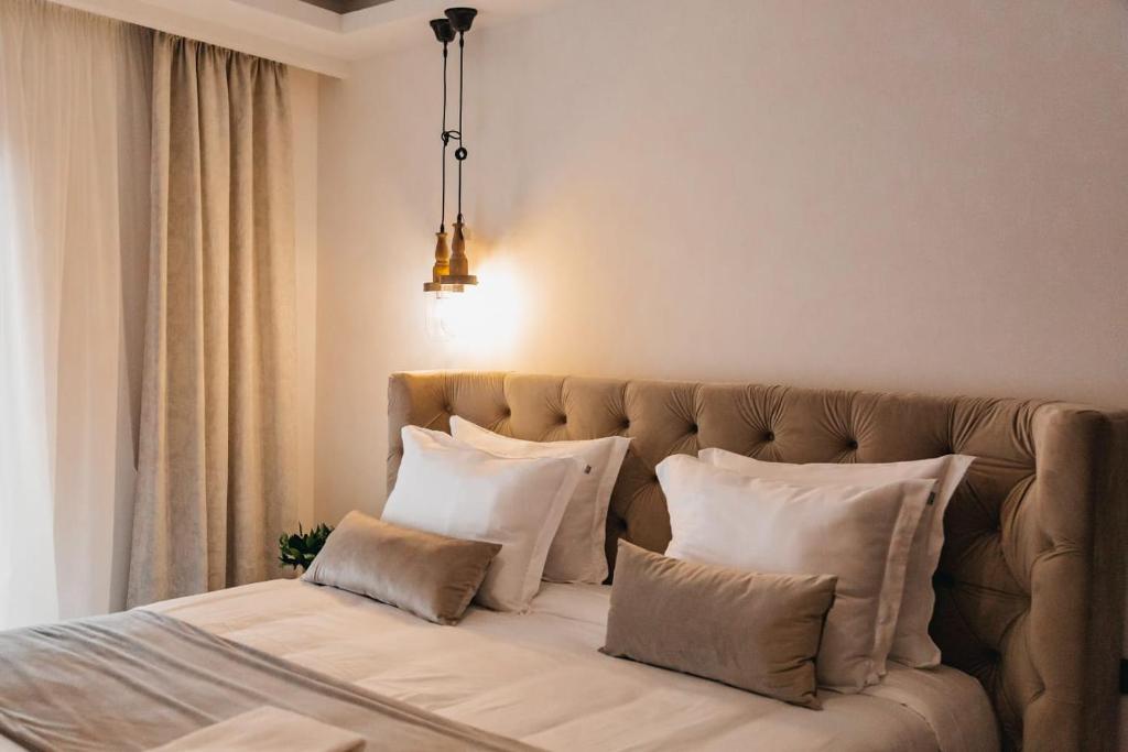 a bedroom with a large bed with white pillows at The berg's 2 in Ocna-Mureşului