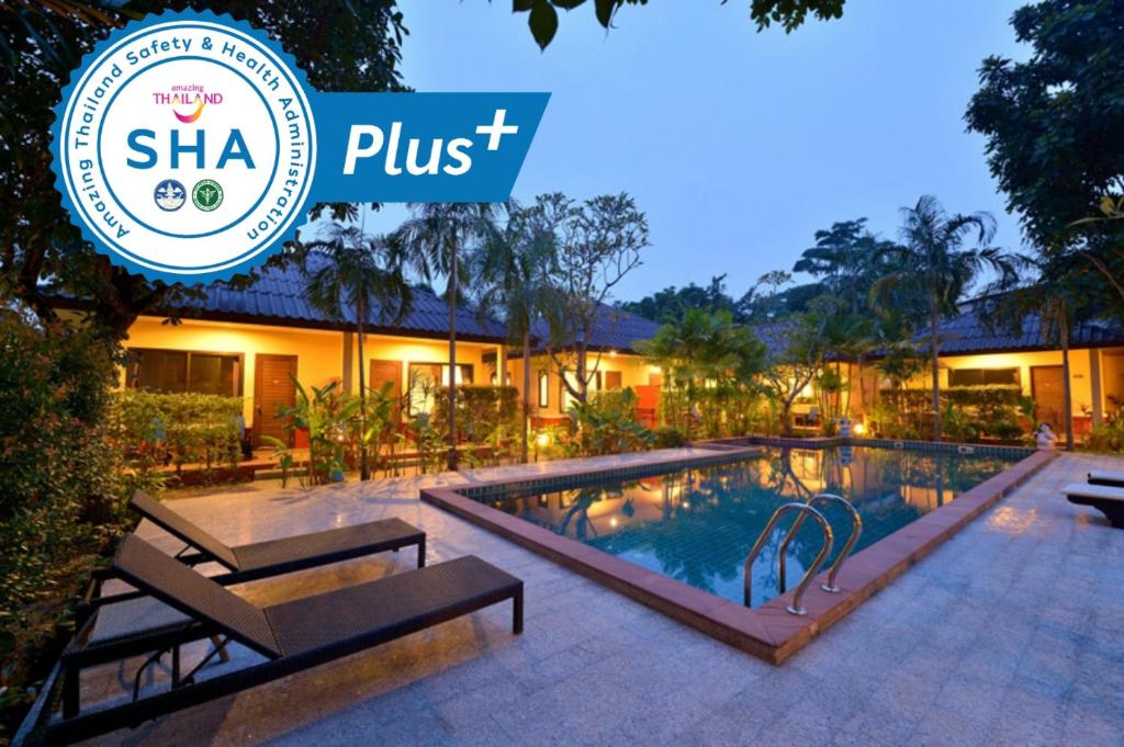 a resort with a swimming pool and a sign that reads shha plus at Happy Cottage in Chalong