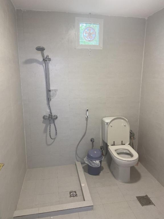a bathroom with a shower and a toilet at Desert Dune Farmhouse - By Seven Elements in Ras al Khaimah