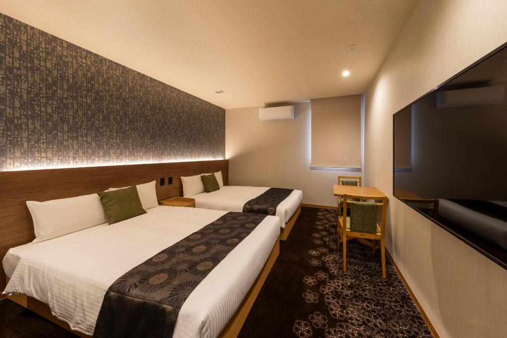 Postel nebo postele na pokoji v ubytování Chiyokura HOTEL SHUKU Nagoya