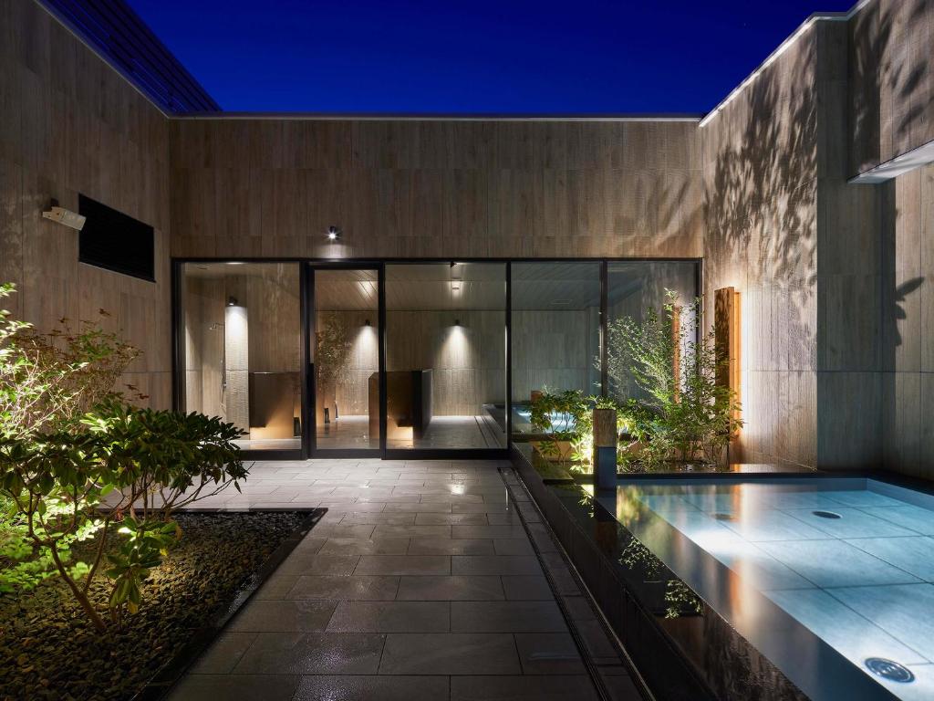 an external view of a house with a swimming pool at Sapporo Granbell Hotel in Sapporo