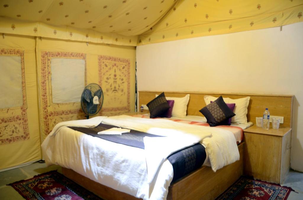 a bedroom with a large bed in a tent at Best Desert Camps Jaisalmer in Jaisalmer