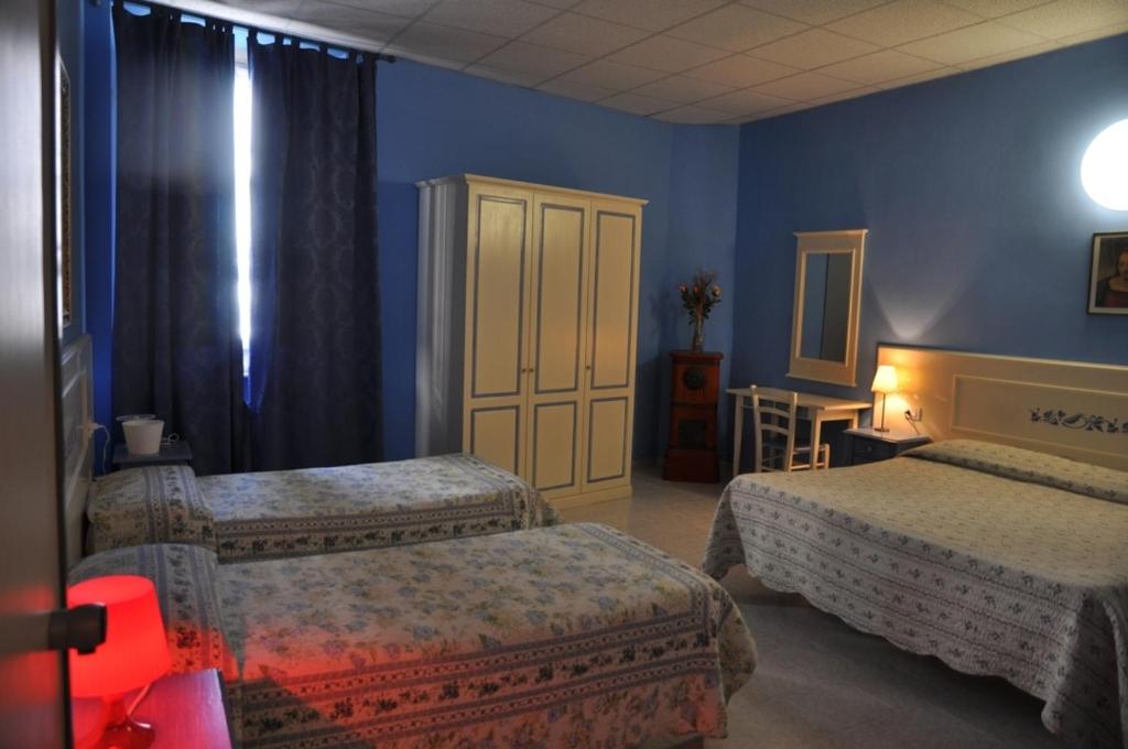 Postel nebo postele na pokoji v ubytování Hotel Regina