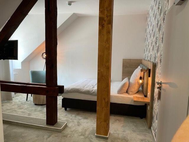 Postel nebo postele na pokoji v ubytování Hotel Le Filou