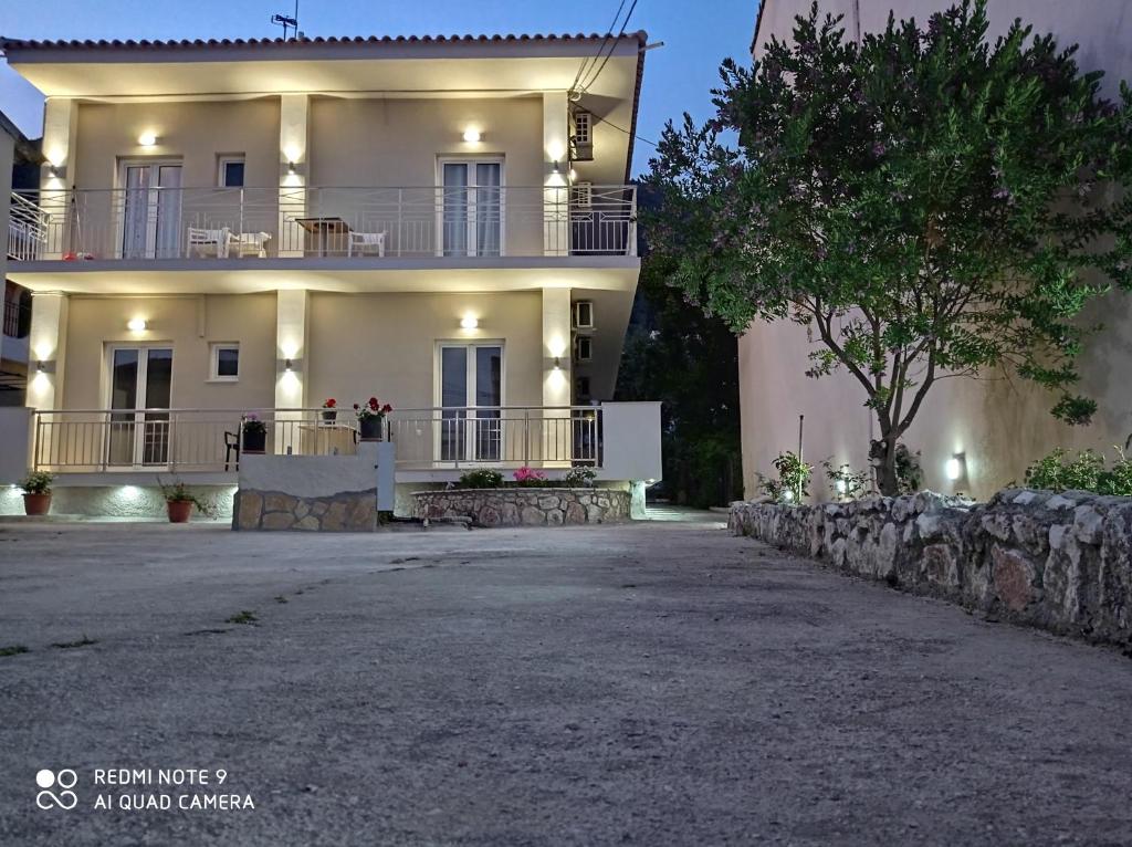 uma grande casa branca com luzes ao lado em KELLY APARTMENTS em Ýpsos