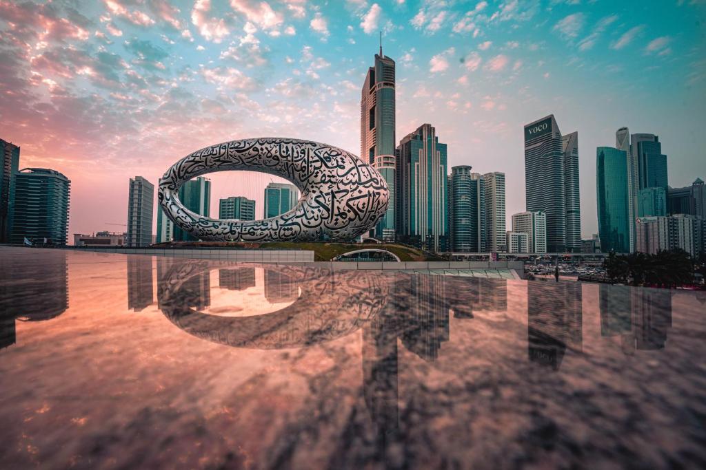 a view of a city skyline with a sculpture at Millennium Plaza Downtown, Dubai in Dubai