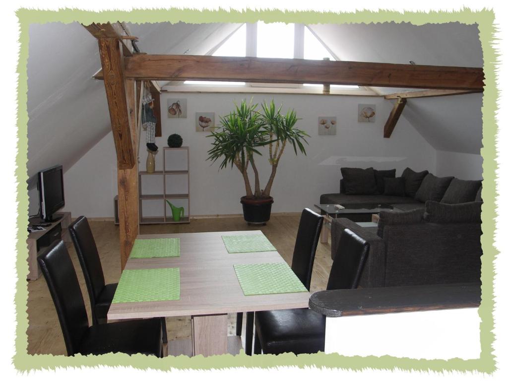 a living room with a table and a couch at Ferienwohung zum Bernerhof in Lindenberg