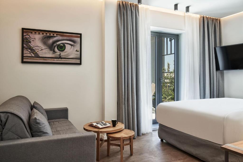 A bed or beds in a room at NLH KERAMEIKOS - Neighborhood Lifestyle Hotels