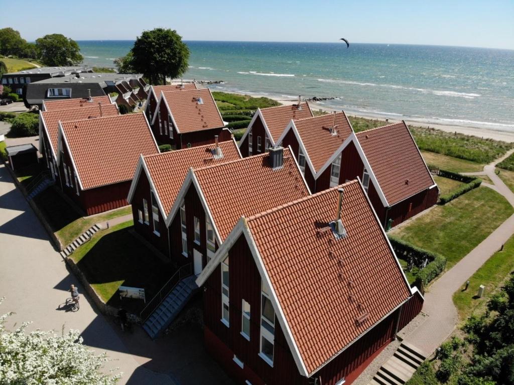 an overhead view of a row of houses near the ocean at Coast in Rettin