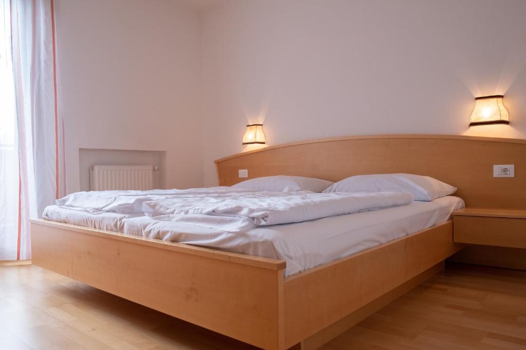 uma cama grande com dois candeeiros em cima em Fewo Zweiraum im Haus Götsch 5 em Parcines