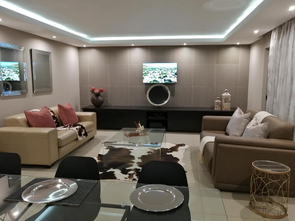 a living room with a couch and a table at Shai's Nest in Centurion