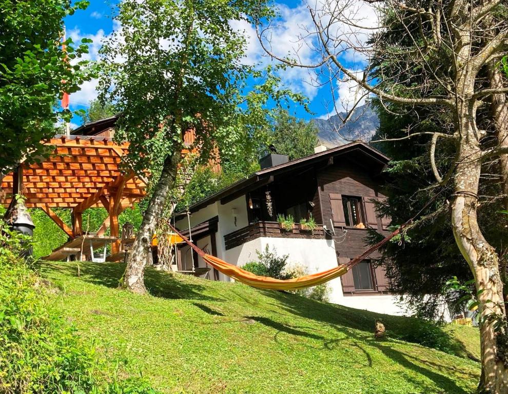 a hammock hanging in front of a house at Töniberg Lounge in Elm