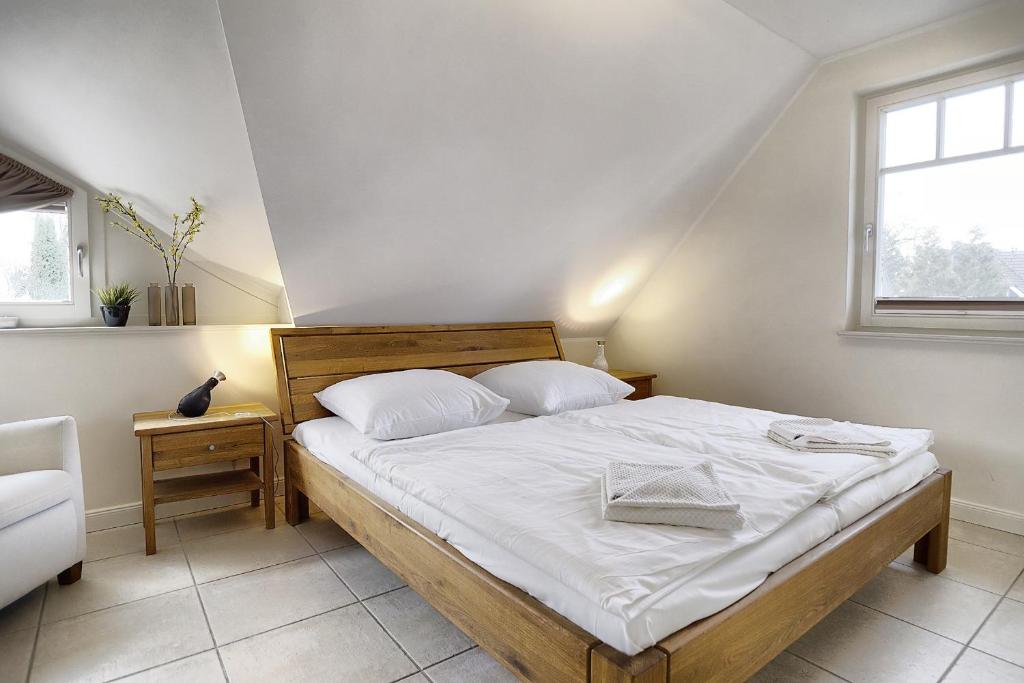 ツィングストにあるSommer Hüskenのベッドルーム1室(白いシーツ付きのベッド1台、窓付)