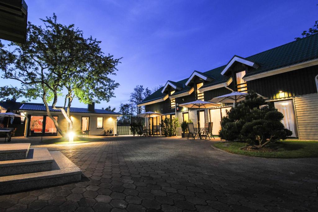 a large building with a courtyard at night at Sodyba prie jūros in Palanga