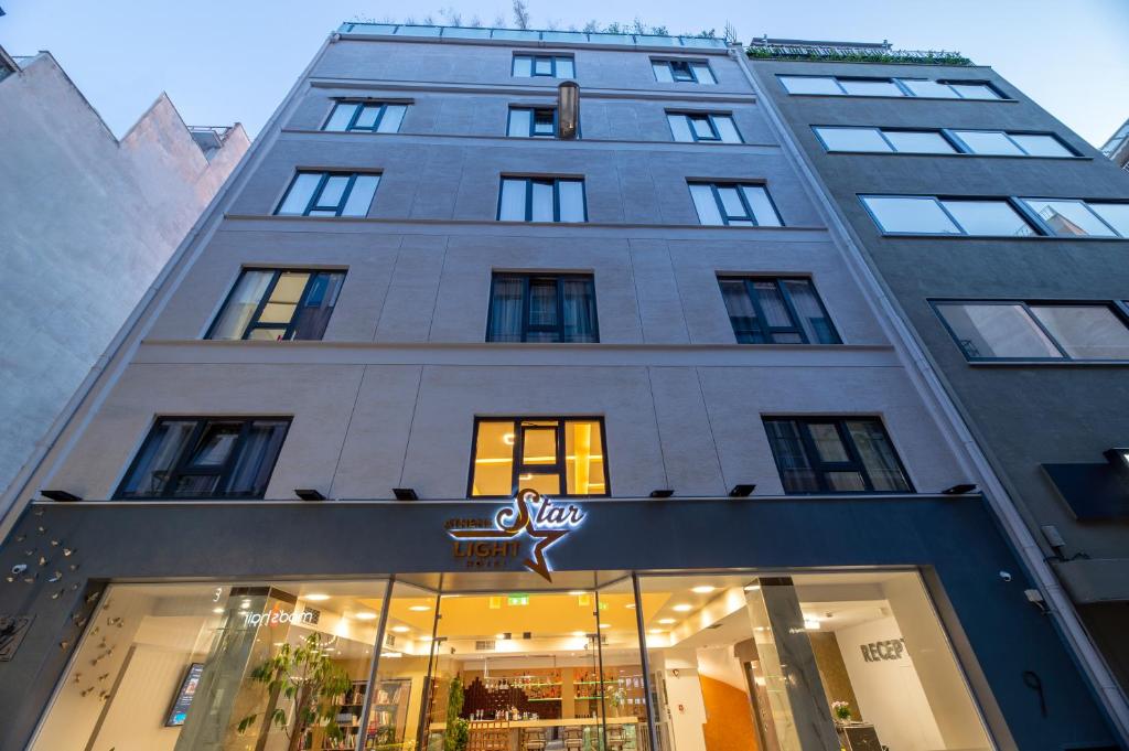 Un palazzo alto con un negozio di fronte di Athens Starlight Hotel ad Atene