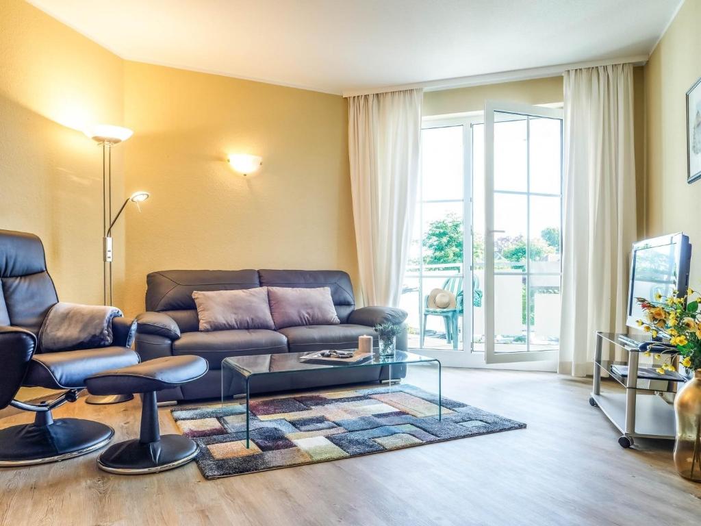 a living room with a couch and a glass table at Strandstraße 51 Whg 1 in Zingst