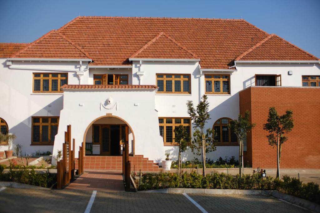 a white house with a red roof at Sanctuary Mandela in Johannesburg
