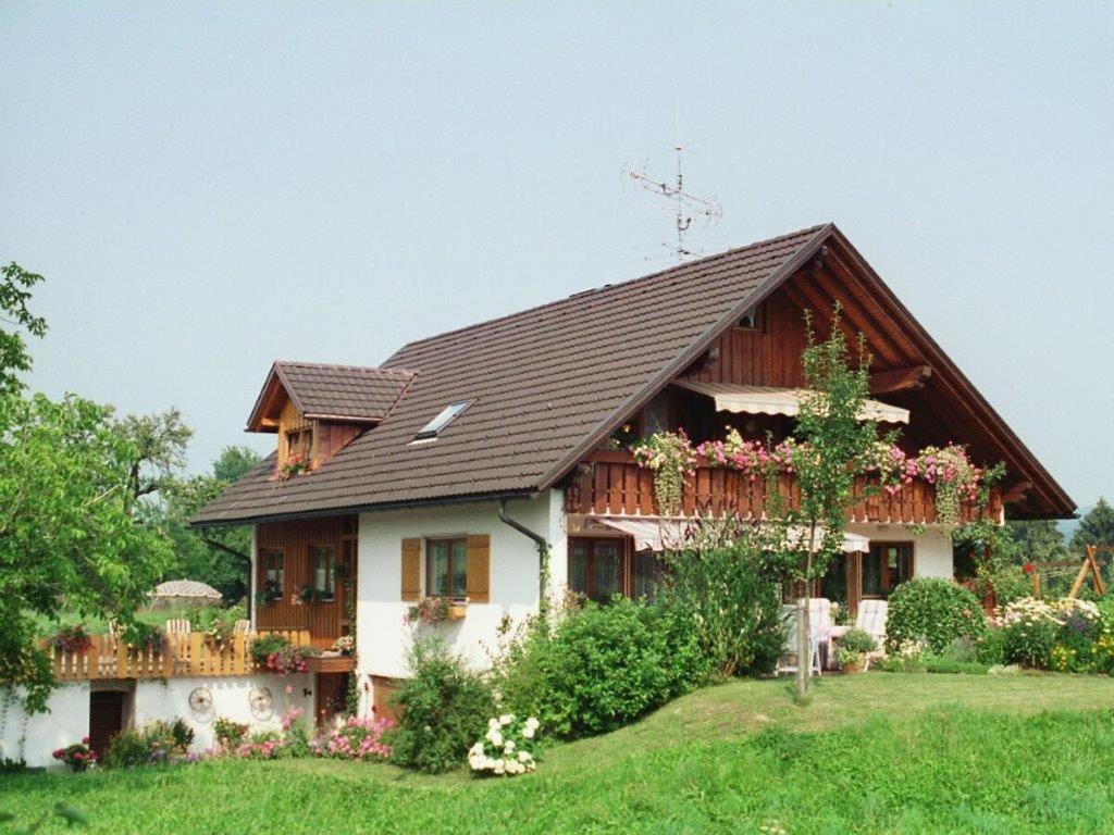 a large house with a brown roof at Ferienwohnung Säntisblick in Hergensweiler