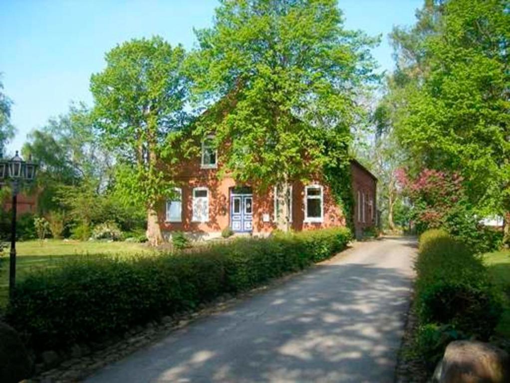 a red brick house with a road in front of it at "Ferienhaus Vadersdorf" Wohnung 1 in Vadersdorf