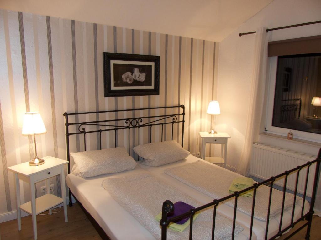 a bedroom with a bed with two tables and two lamps at Ferienhaus Sonnenaufgang in Walsrode