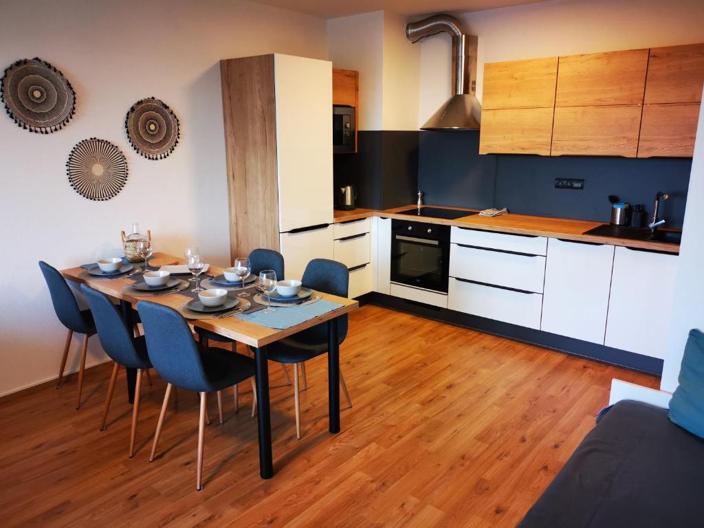 a kitchen with a table and chairs in a room at KaVi Apartments #3, TOP city view! in Plzeň
