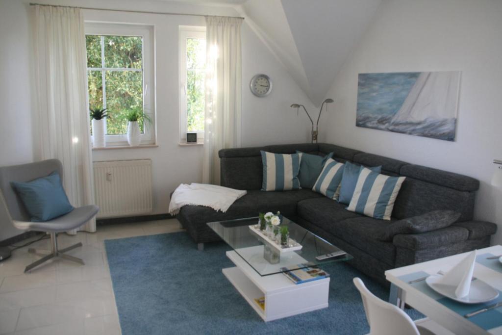 a living room with a couch and a table at Strandstraße 21 Whg 5 in Zingst