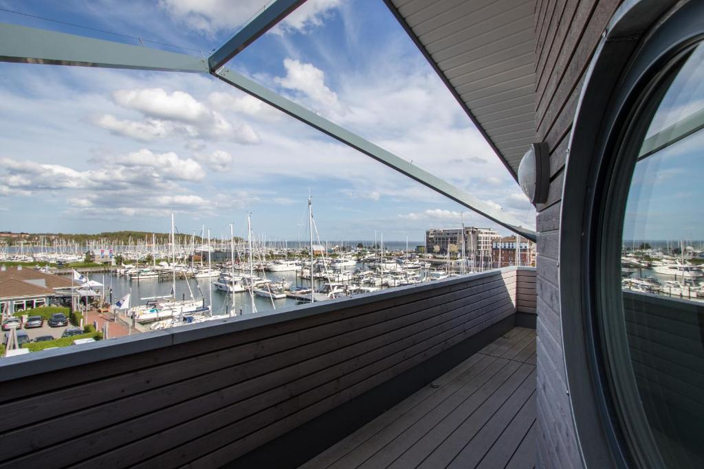 a balcony with a view of a marina at ancora Marina Haus 1 Penthouse in Neustadt in Holstein