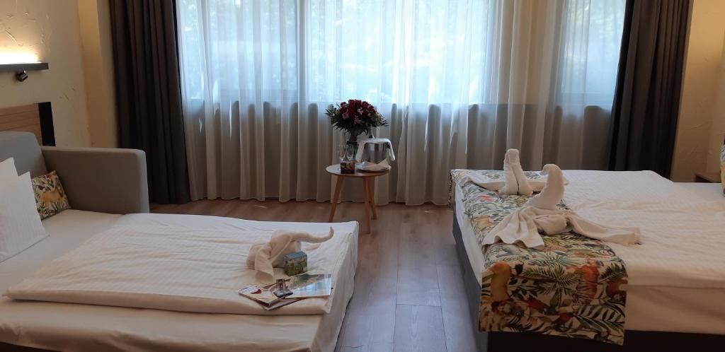 Łóżko lub łóżka w pokoju w obiekcie Pangea Hotel